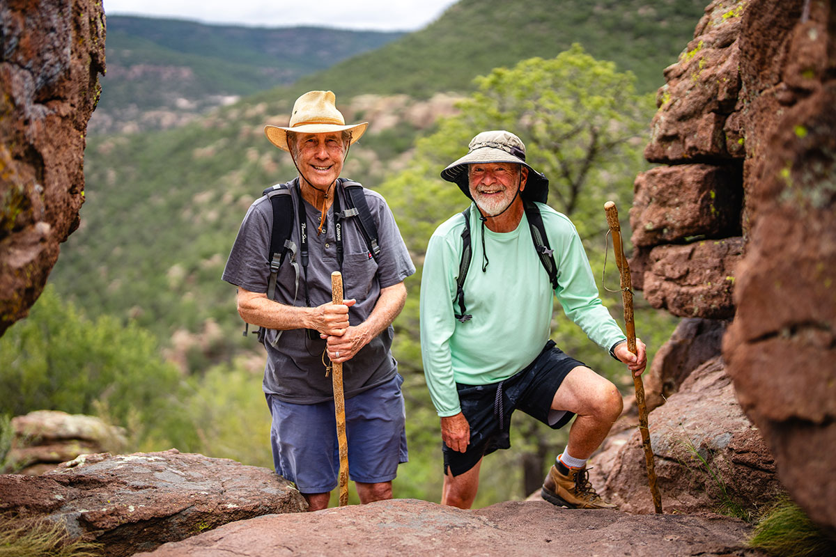 Two active elder men hiking in the mountains